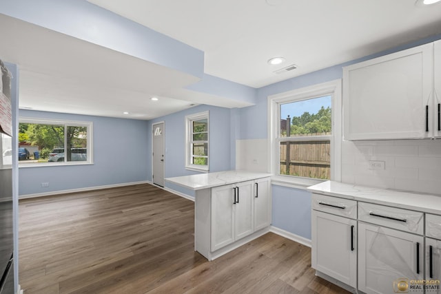 9509 S Merrion Ave, Chicago, IL 60617 - kitchen with wood finished floors, a peninsula, white cabinets, healthy amount of natural light, and recessed lighting