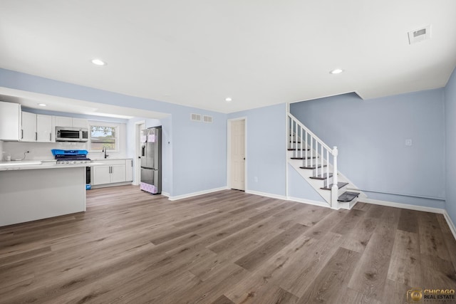 9509 S Merrion Ave, Chicago, IL 60617 - unfurnished living room with stairway, light wood finished floors, and recessed lighting