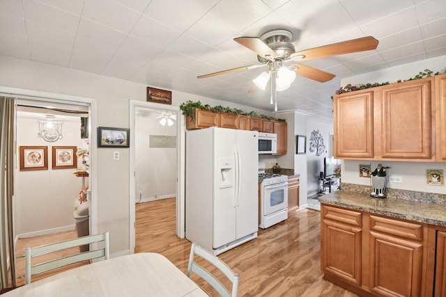 4842 S Wallace St, Chicago, IL 60609 - kitchen with white appliances, light wood-style flooring, ceiling fan, and brown cabinets