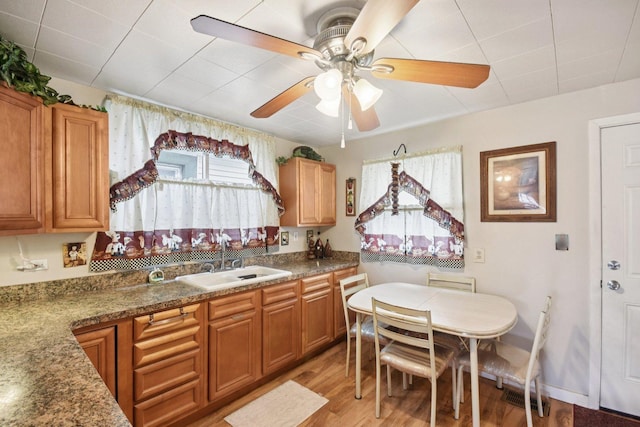4842 S Wallace St, Chicago, IL 60609 - kitchen featuring light wood-style floors, ceiling fan, and brown cabinets