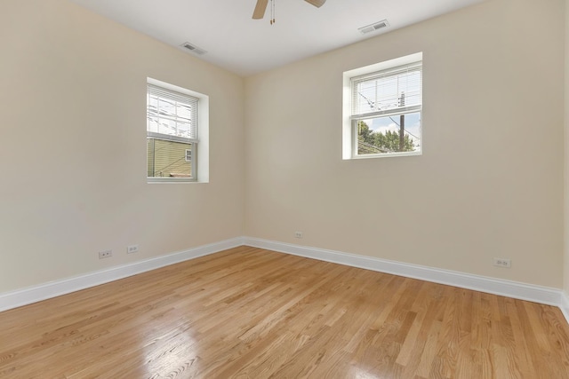 3415 W Berteau Ave Unit 1, Chicago, IL 60618 - spare room featuring healthy amount of natural light, light wood-style flooring, and ceiling fan