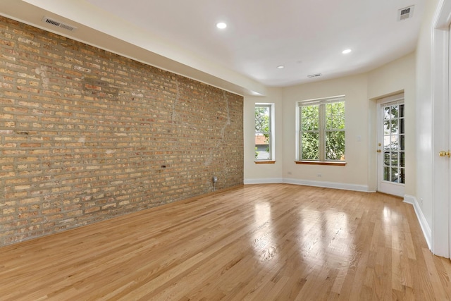 3415 W Berteau Ave Unit 1, Chicago, IL 60618 - spare room with brick wall, wood finished floors, and recessed lighting