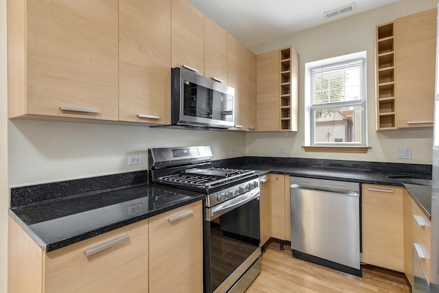 3415 W Berteau Ave Unit 1, Chicago, IL 60618 - kitchen with appliances with stainless steel finishes, light brown cabinets, light wood finished floors, open shelves, and dark stone countertops