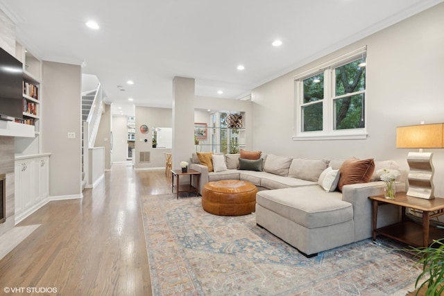 1212 W School St, Chicago, IL 60657 - living area featuring wood finished floors, plenty of natural light, recessed lighting, stairway, and ornamental molding