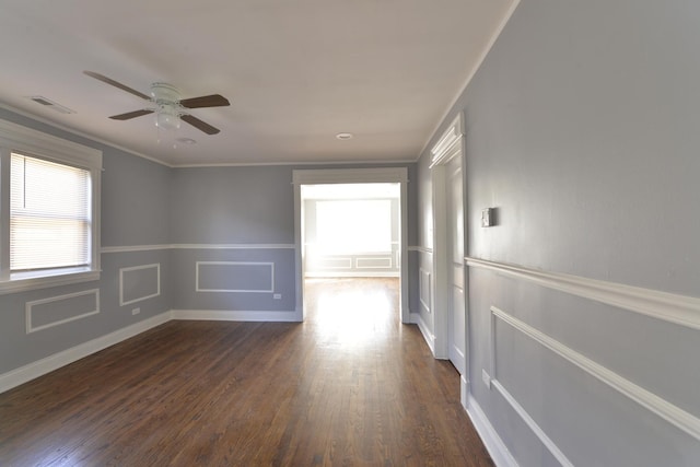 422 Sibley Blvd, Calumet City, IL 60409 - spare room with dark wood-type flooring, ceiling fan, crown molding, and a decorative wall