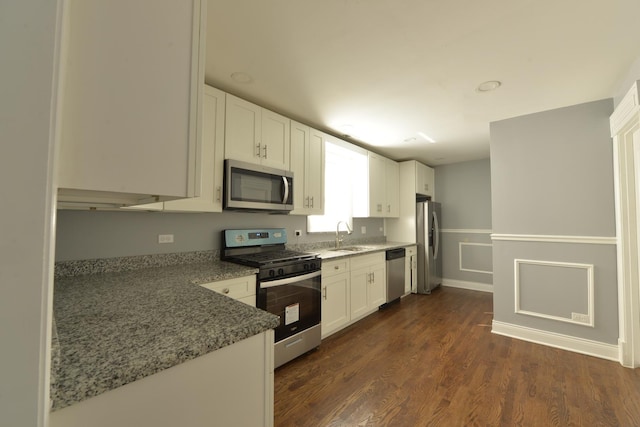 422 Sibley Blvd, Calumet City, IL 60409 - kitchen featuring stainless steel appliances, white cabinets, light stone counters, and dark wood-style flooring