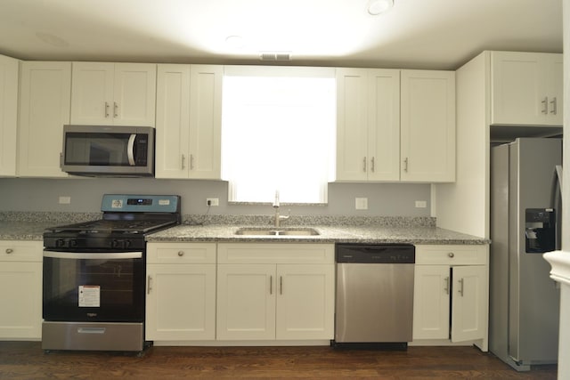 422 Sibley Blvd, Calumet City, IL 60409 - kitchen featuring stainless steel appliances, white cabinets, light stone countertops, and dark wood-style floors