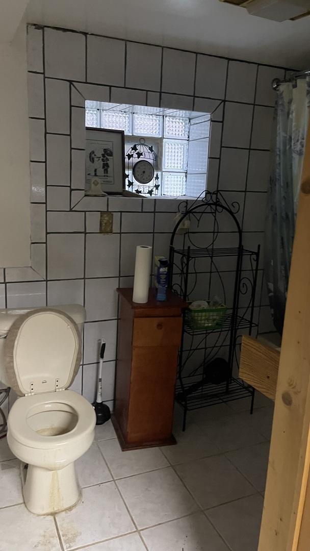 4838 S Bishop St, Chicago, IL 60609 - bathroom with tile patterned flooring, tile walls, and curtained shower