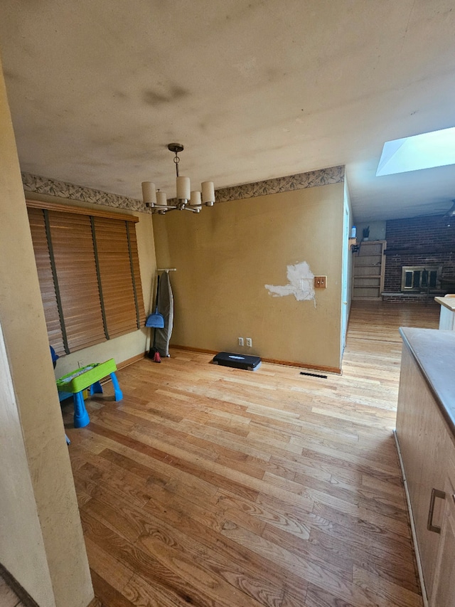 340 Somerset Dr, Streamwood, IL 60107 - unfurnished dining area with wood finished floors, a chandelier, and a skylight