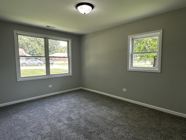 207 W 2nd St, Streator, IL 61364 - unfurnished room featuring baseboards and dark colored carpet