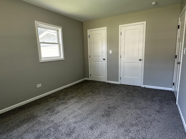 207 W 2nd St, Streator, IL 61364 - unfurnished bedroom with dark colored carpet and baseboards