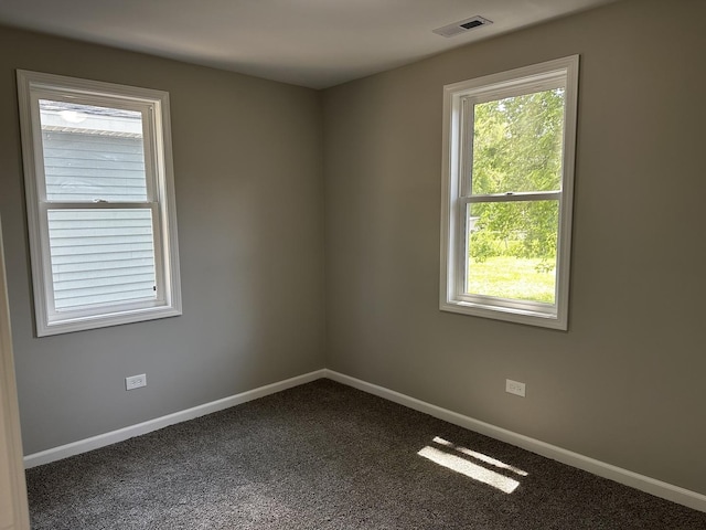 207 W 2nd St, Streator, IL 61364 - unfurnished room with baseboards and dark colored carpet