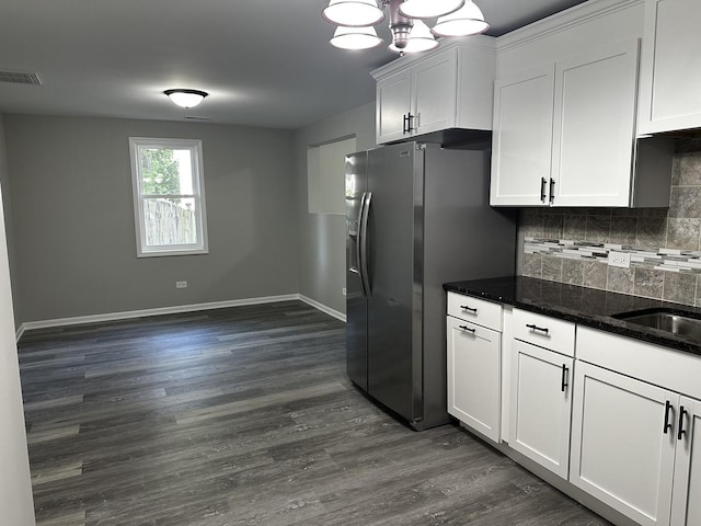 207 W 2nd St, Streator, IL 61364 - kitchen featuring stainless steel fridge, backsplash, white cabinets, dark wood-style flooring, and dark stone counters