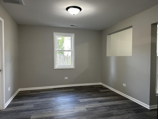207 W 2nd St, Streator, IL 61364 - spare room with dark wood-type flooring and baseboards