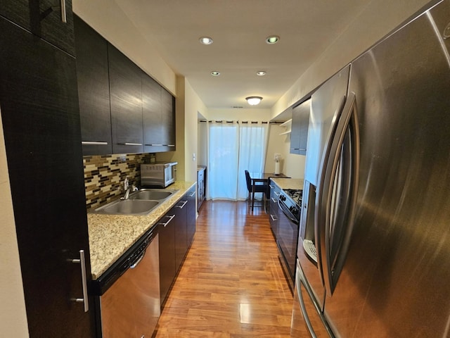 50 Old Oak Dr Unit 114, Buffalo Grove, IL 60089 - kitchen featuring stainless steel appliances, dark cabinets, light wood-style floors, modern cabinets, and recessed lighting