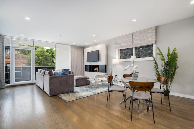 927 N Damen Ave Unit 2, Chicago, IL 60622 - living room with wood finished floors, recessed lighting, a lit fireplace, and a wall of windows