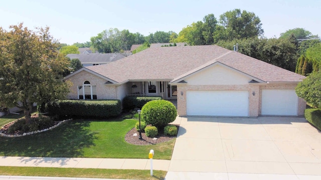 396 W 8th St, Manteno, IL 60950 - single story home with a garage, a front lawn, driveway, brick siding, and a shingled roof