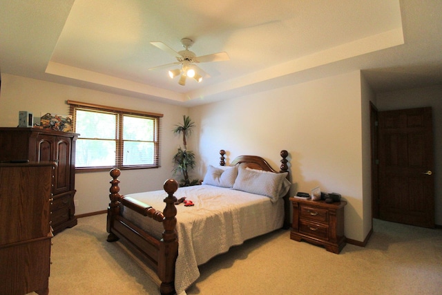 396 W 8th St, Manteno, IL 60950 - bedroom featuring a tray ceiling, light carpet, and a ceiling fan