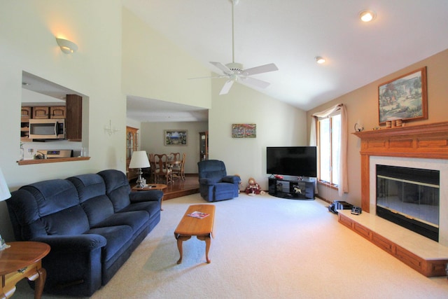 396 W 8th St, Manteno, IL 60950 - living area featuring carpet flooring, a ceiling fan, a glass covered fireplace, high vaulted ceiling, and recessed lighting