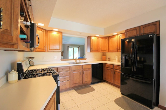396 W 8th St, Manteno, IL 60950 - kitchen featuring black appliances, light countertops, brown cabinetry, and recessed lighting