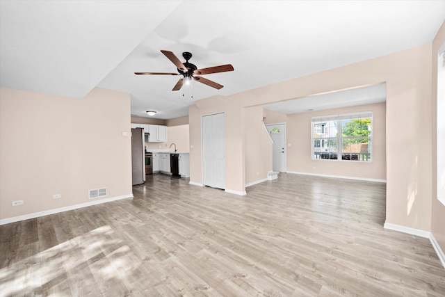 995 Serendipity Dr, Aurora, IL 60504 - unfurnished living room with a ceiling fan and light wood-style flooring