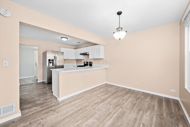 995 Serendipity Dr, Aurora, IL 60504 - kitchen with stainless steel refrigerator with ice dispenser, a peninsula, light wood-style flooring, light countertops, and white cabinets