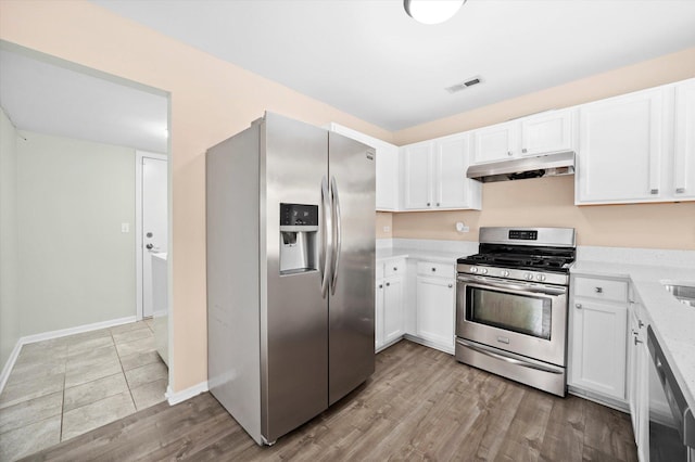 995 Serendipity Dr, Aurora, IL 60504 - kitchen featuring stainless steel appliances, under cabinet range hood, white cabinets, and light wood finished floors