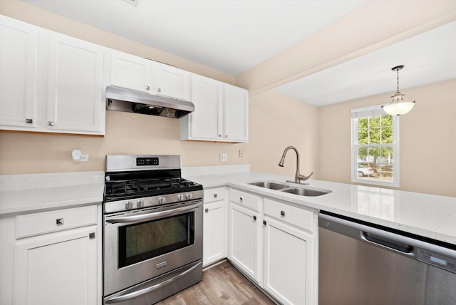995 Serendipity Dr, Aurora, IL 60504 - kitchen with stainless steel appliances, under cabinet range hood, white cabinetry, and pendant lighting