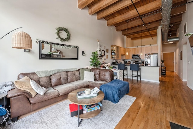 525 W Superior St Unit 224, Chicago, IL 60654 - living area featuring a high ceiling, wood finished floors, and a wood ceiling with exposed beams
