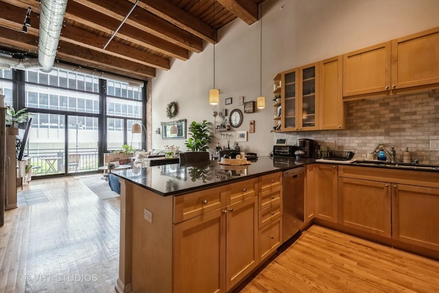 525 W Superior St Unit 224, Chicago, IL 60654 - kitchen featuring dishwasher, light wood-type flooring, tasteful backsplash, a peninsula, and glass insert cabinets