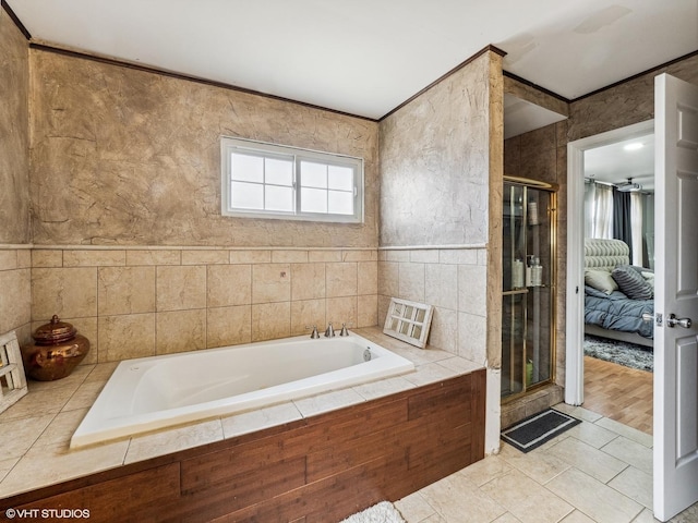 665 Cindy Ln, Wheeling, IL 60090 - full bath featuring a garden tub, a stall shower, ensuite bathroom, tile patterned flooring, and tile walls