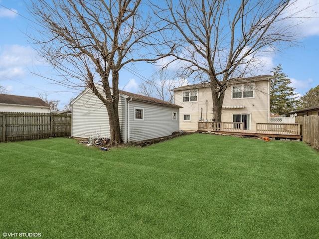 665 Cindy Ln, Wheeling, IL 60090 - rear view of house featuring a fenced backyard, a deck, and an outbuilding