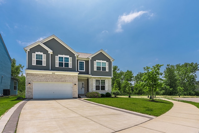 241 Stonington Dr, Bloomingdale, IL 60108 - view of front of property with driveway, brick siding, an attached garage, and a front yard