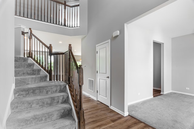 241 Stonington Dr, Bloomingdale, IL 60108 - stairs with wood finished floors and a towering ceiling