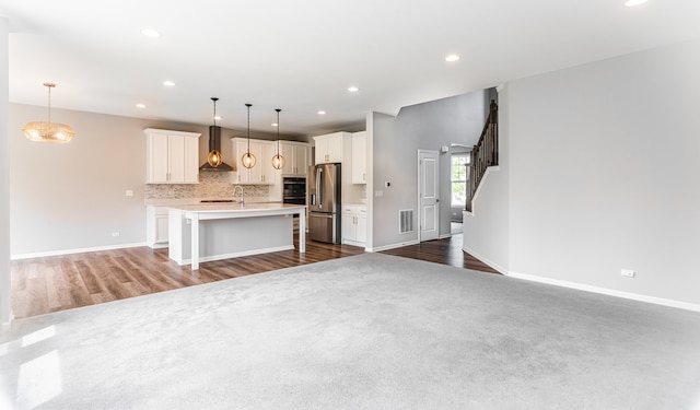 241 Stonington Dr, Bloomingdale, IL 60108 - kitchen featuring wall chimney exhaust hood, stainless steel fridge with ice dispenser, open floor plan, light countertops, and recessed lighting
