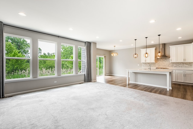 241 Stonington Dr, Bloomingdale, IL 60108 - unfurnished living room featuring dark colored carpet, recessed lighting, and dark wood-style floors