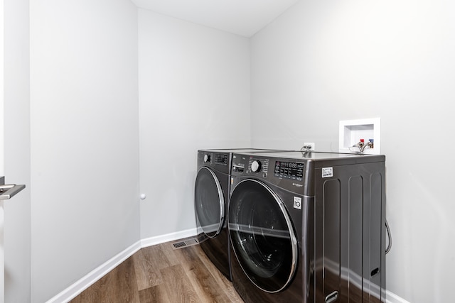 241 Stonington Dr, Bloomingdale, IL 60108 - laundry room with independent washer and dryer and wood finished floors