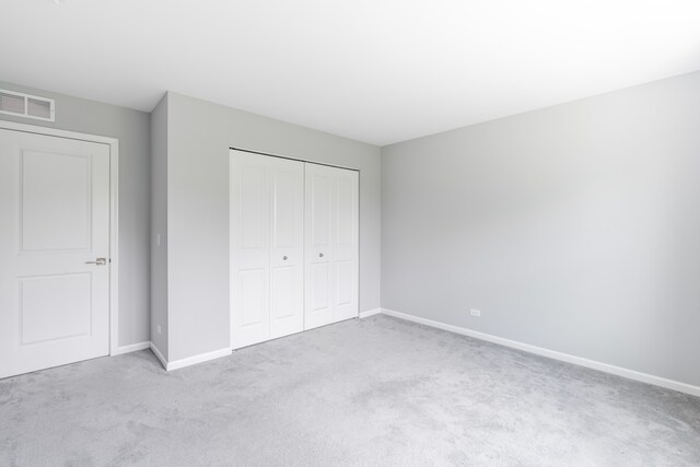241 Stonington Dr, Bloomingdale, IL 60108 - unfurnished bedroom featuring carpet floors and a closet