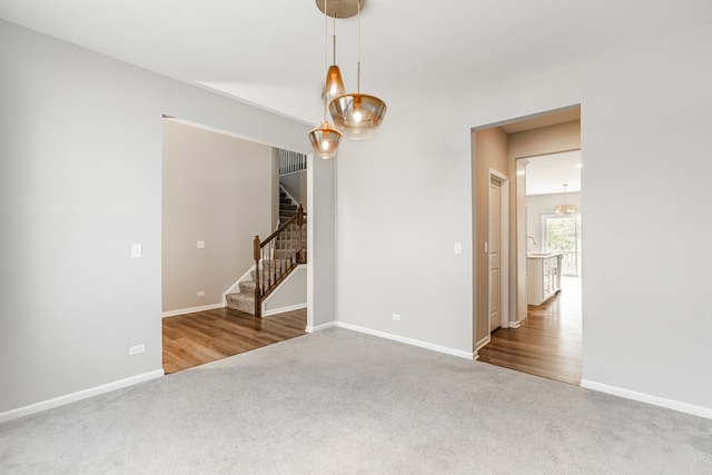 241 Stonington Dr, Bloomingdale, IL 60108 - carpeted spare room featuring stairway and a chandelier