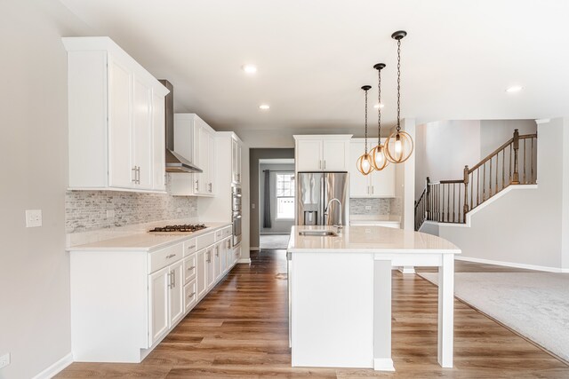 241 Stonington Dr, Bloomingdale, IL 60108 - kitchen featuring stainless steel appliances, wall chimney range hood, light countertops, a breakfast bar area, and recessed lighting