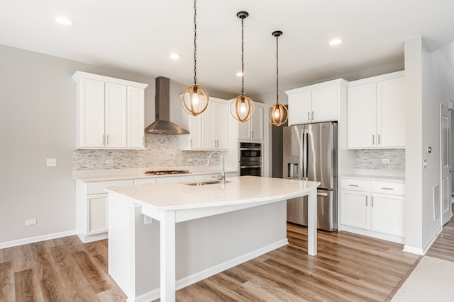 241 Stonington Dr, Bloomingdale, IL 60108 - kitchen featuring stainless steel appliances, wall chimney exhaust hood, light wood-style floors, light countertops, and recessed lighting