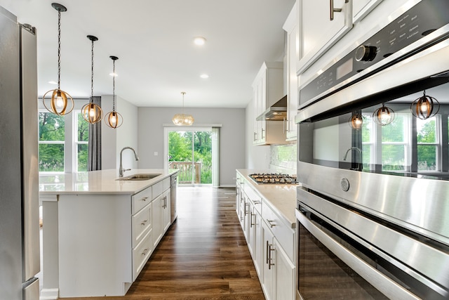 241 Stonington Dr, Bloomingdale, IL 60108 - kitchen with stainless steel appliances, dark wood finished floors, white cabinets, recessed lighting, and a kitchen island with sink