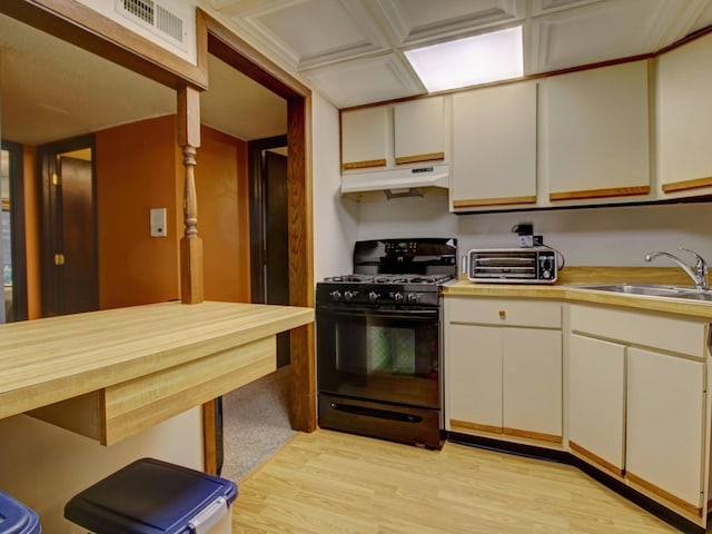14624 Scarborough Ct S Unit G-1, Oak Forest, IL 60452 - kitchen with black range with gas cooktop, under cabinet range hood, light wood-style flooring, white cabinets, and butcher block counters