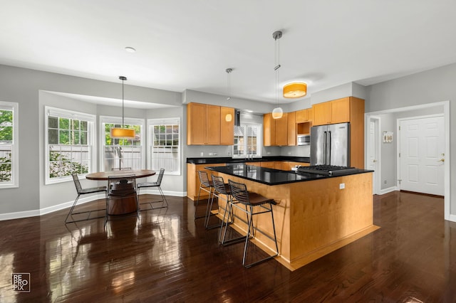 100 Homestead Dr, Wood Dale, IL 60191 - kitchen featuring stainless steel appliances, a center island, dark countertops, dark wood-type flooring, and hanging light fixtures