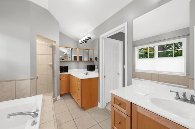 100 Homestead Dr, Wood Dale, IL 60191 - bathroom featuring lofted ceiling, two vanities, tiled shower, tile patterned flooring, and a bath