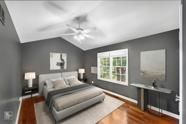 100 Homestead Dr, Wood Dale, IL 60191 - bedroom with wood finished floors, lofted ceiling, and a ceiling fan