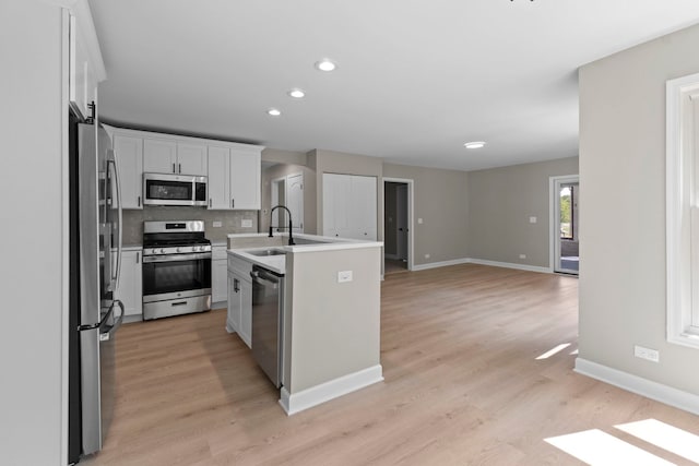 341 Tanager Dr, Woodstock, IL 60098 - kitchen featuring stainless steel appliances, recessed lighting, tasteful backsplash, white cabinetry, and light wood-style flooring