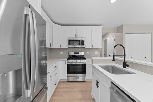 341 Tanager Dr, Woodstock, IL 60098 - kitchen featuring appliances with stainless steel finishes, light wood finished floors, white cabinets, backsplash, and recessed lighting