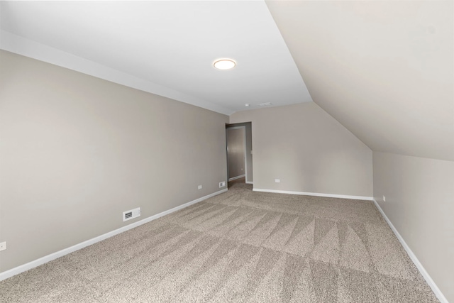341 Tanager Dr, Woodstock, IL 60098 - additional living space featuring vaulted ceiling and light colored carpet