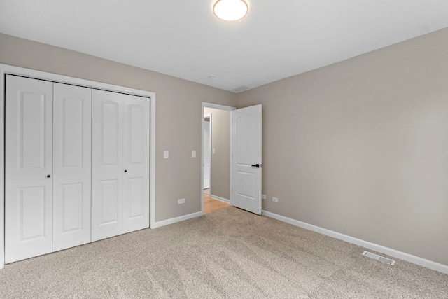341 Tanager Dr, Woodstock, IL 60098 - unfurnished bedroom featuring light carpet and a closet